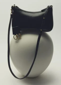 Crossbody bag with charms and rings